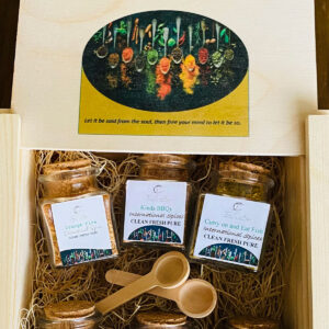 A box of three jars and spoons in it.